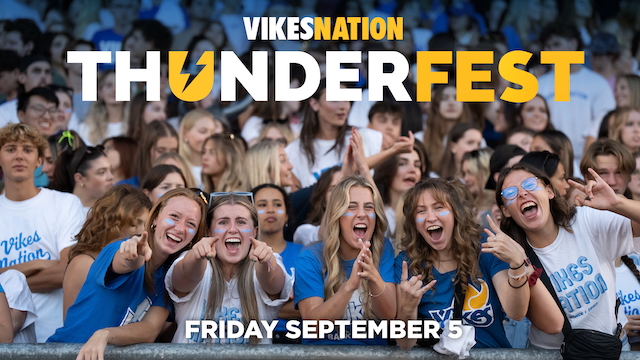 A group of students at a thunderfest soccer game. All of them are happy and cheering. There are the words Vikes Nation Thunderfest overlayed on top.