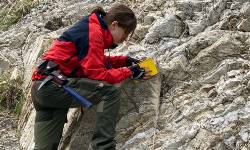 Stacy Edmonsond conducting field work on rock