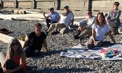 A few faculty members on a rocky beack