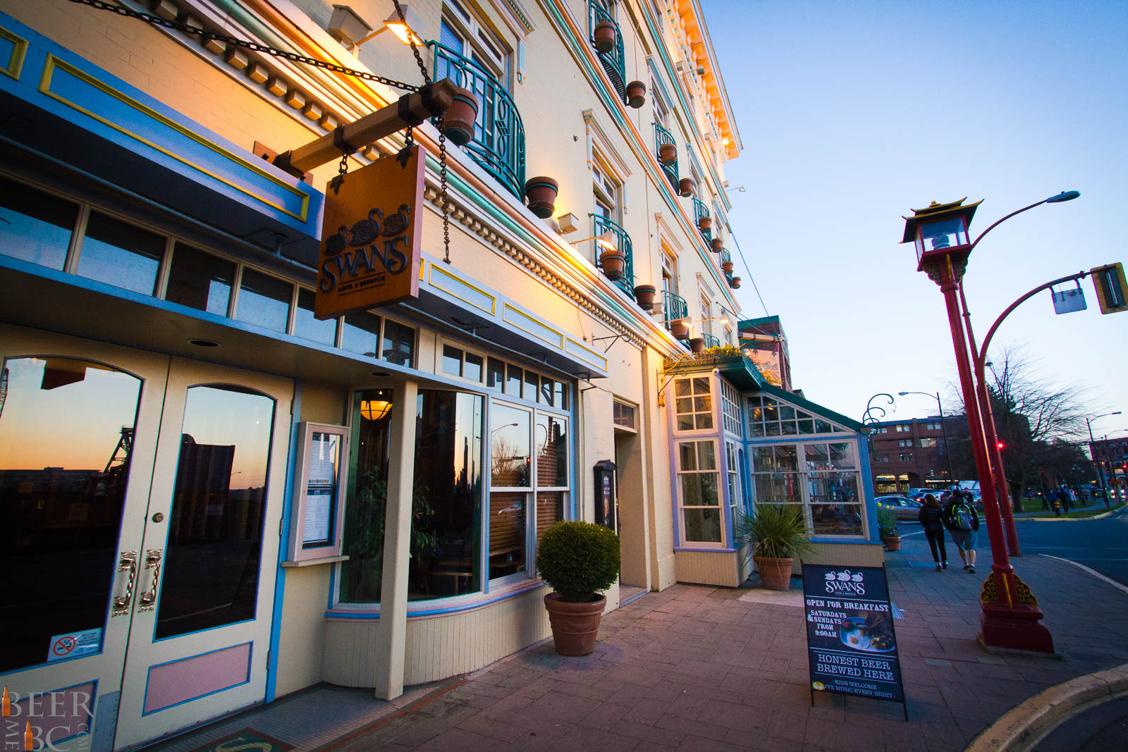 The outside of Swans Brew Pub taken from the sidewalk and looking towards the entrance of the building