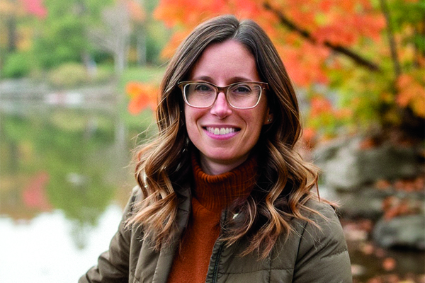 Nadia Frost smiling in the woods.