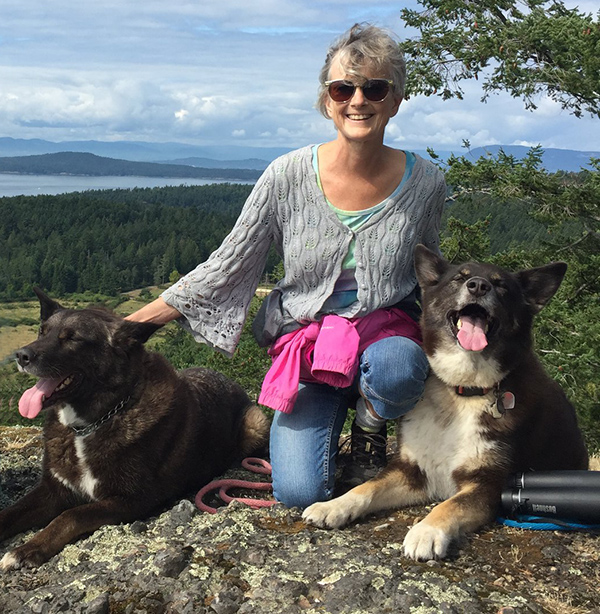 Janet Person posing with her two dogs.
